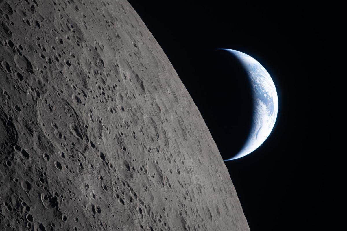 A blue and white crescent Earth appears beyond the cratered gray surface of the Moon against black space.